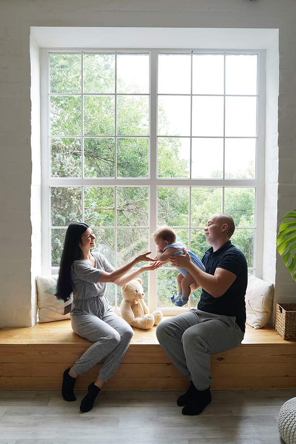 bigstock Young Couple With A Baby Playi 445585769