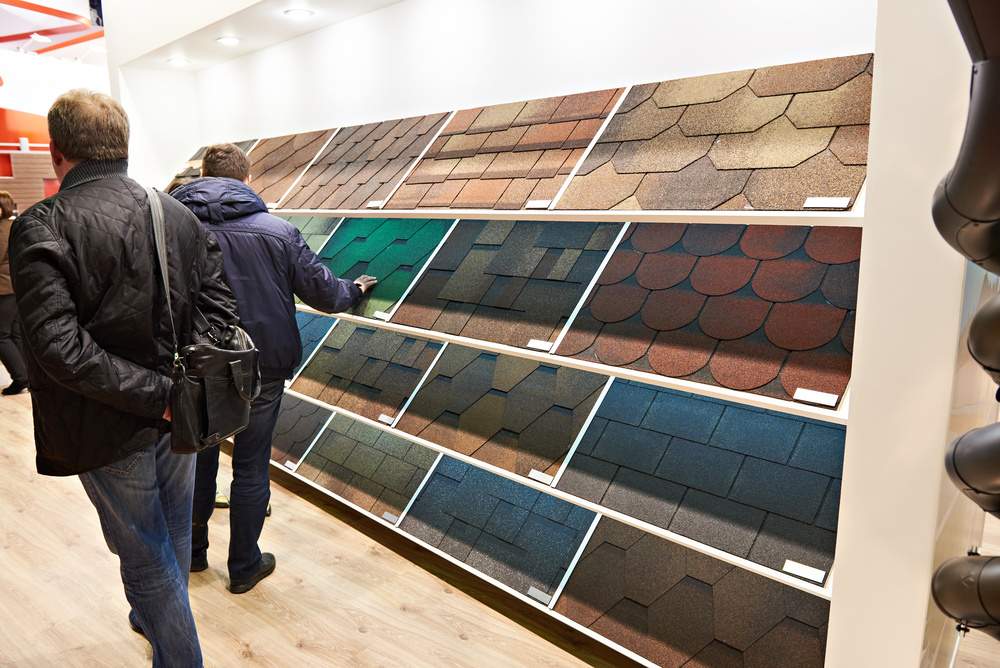buyers in construction shop choose soft roof tiles