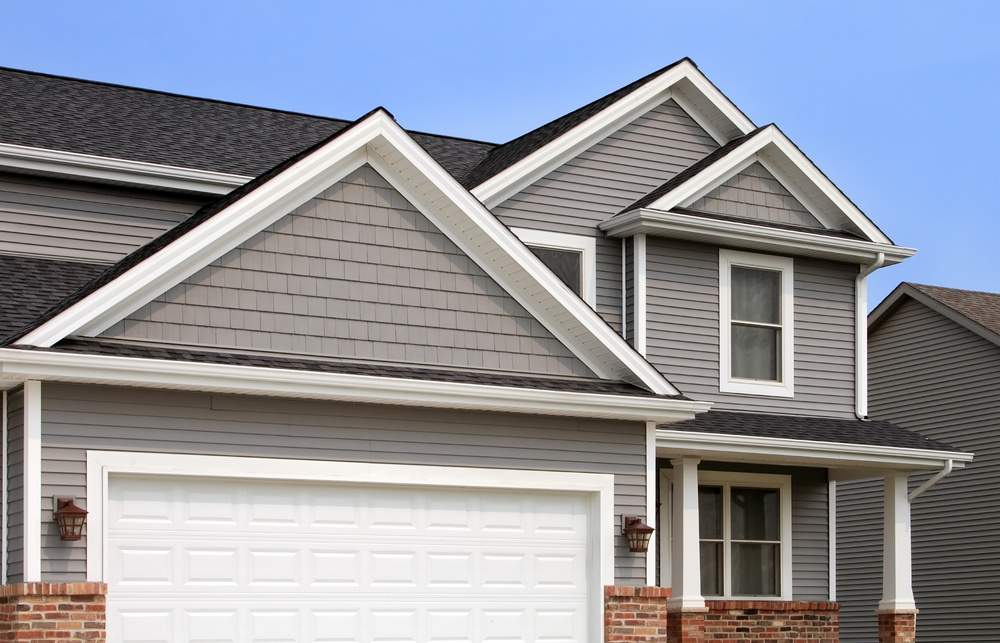 new home with vinyl siding gutters roof